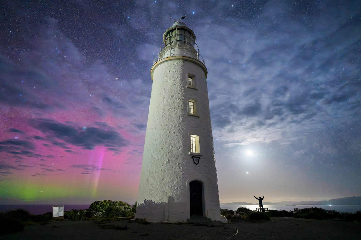A photographer beneath the night sky at Cape Bruny Lighthouse, Tasmania